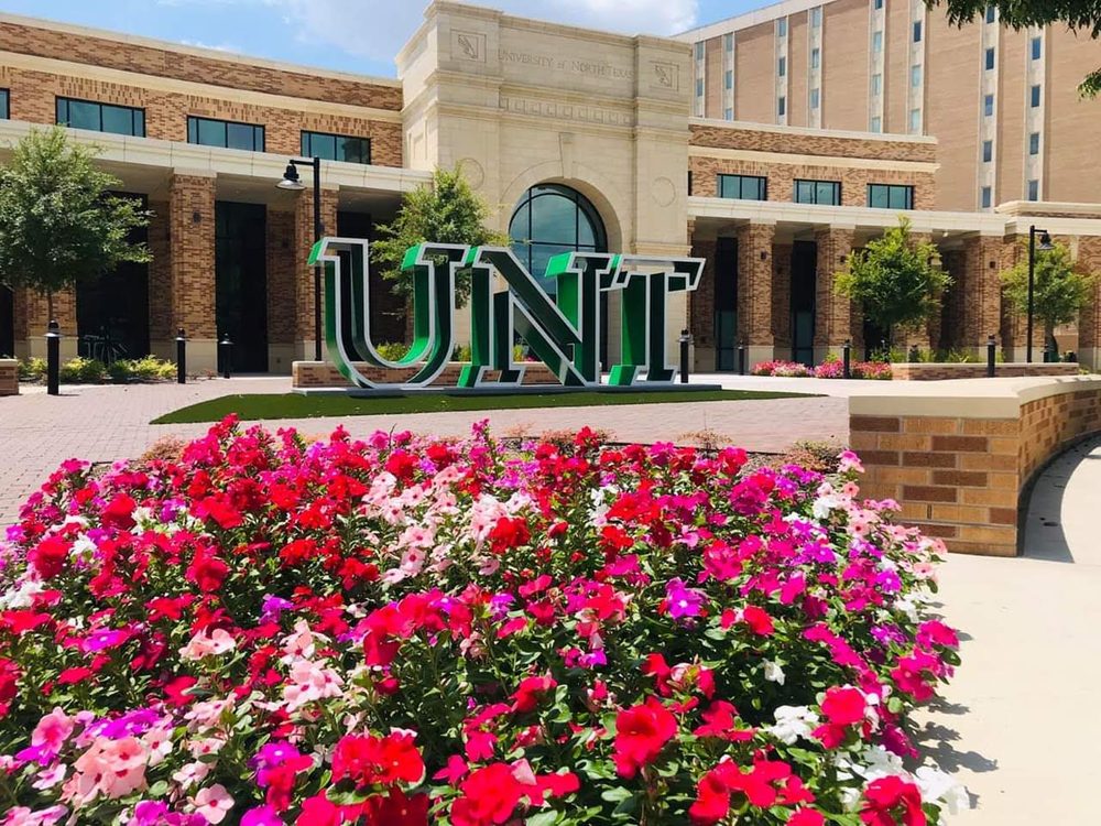 University of North Texas image of front of campus at the welcome center with UNT sign displayed.
