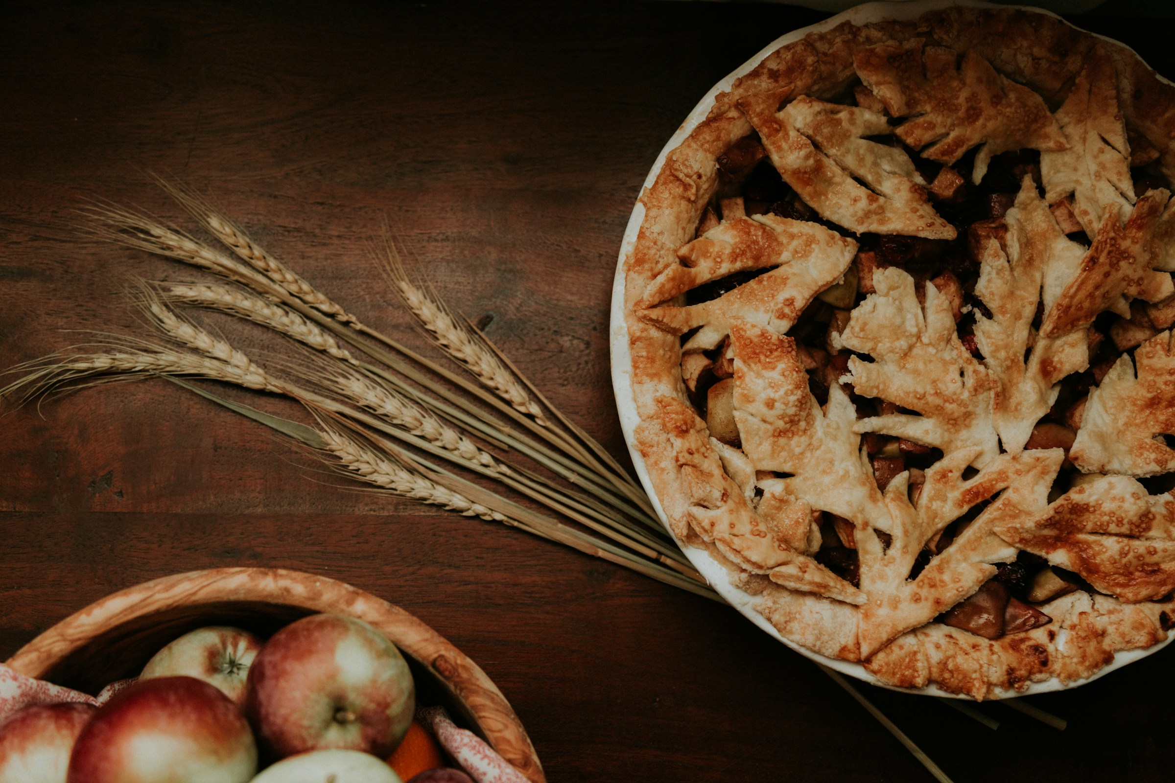 Image of an apple pie next to wheat for the post "Is Gluten-Free Wheat Starch Celiac-Safe".