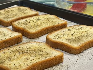 Seasoned Garlic Buttered GF Bread on a sheet pan for Easy Baked Gluten-Free Croutons